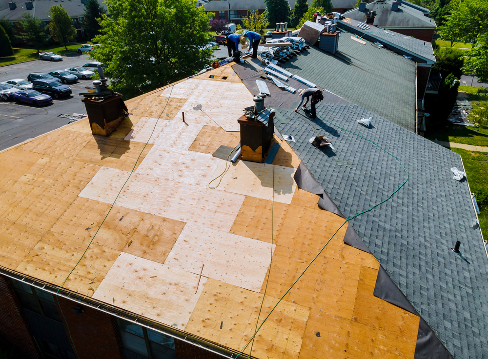 roofers reroofing a home